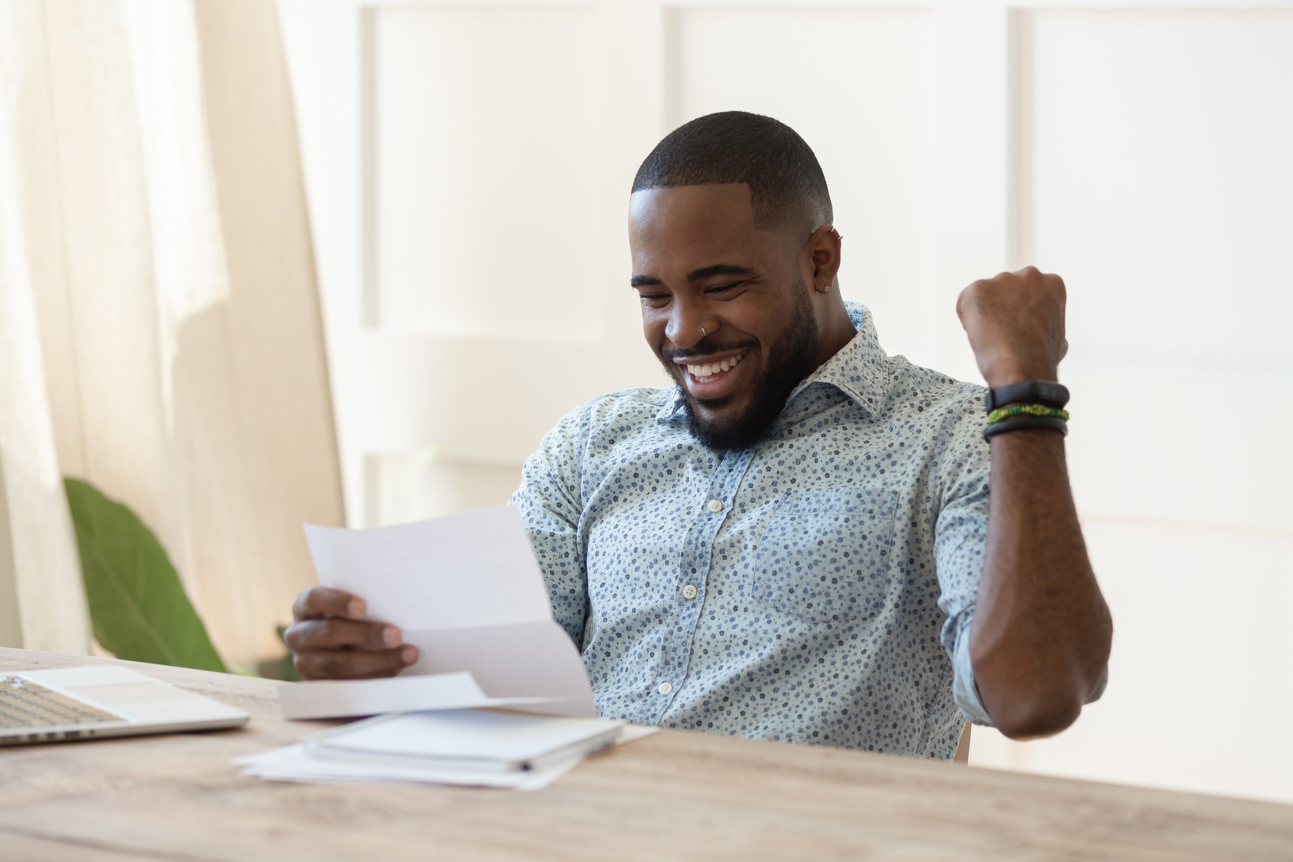 Man is happy to read a paper