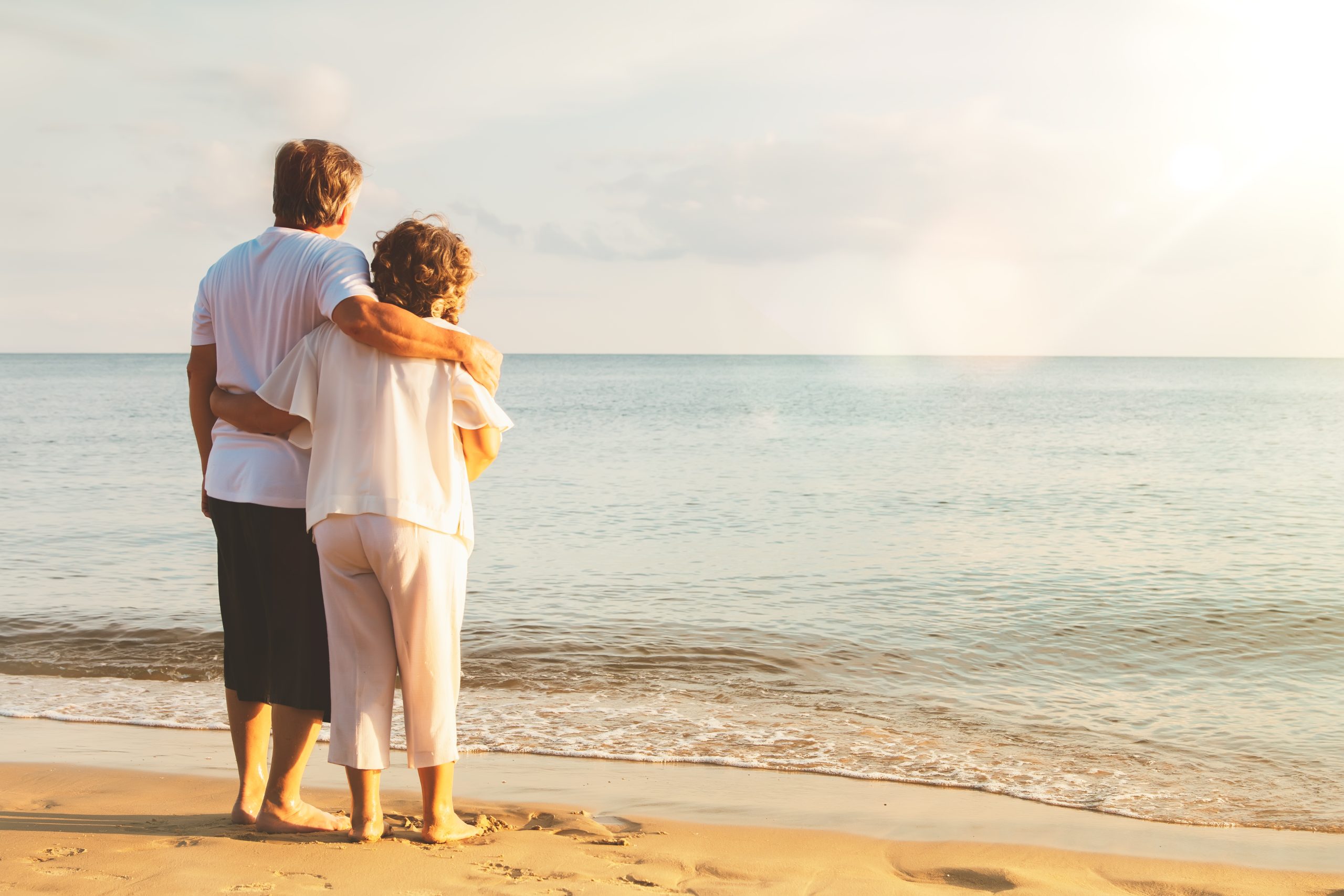 Old couple looking at the sea together